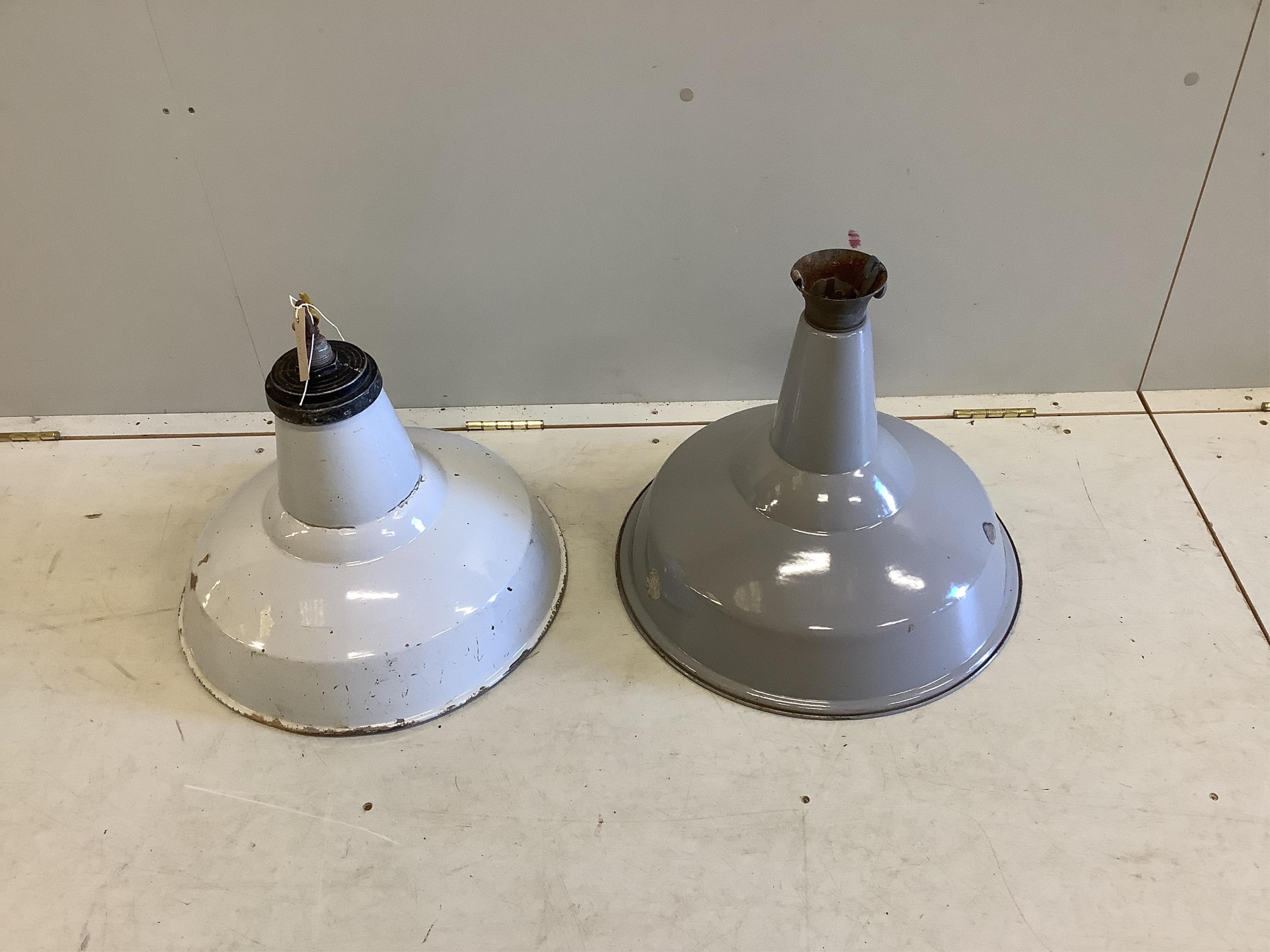 Two vintage Industrial enamelled metal ceiling lamps, larger 48cm diameter, height 38cm. Condition - fair but both have chips to enamel, more severe to the smaller.